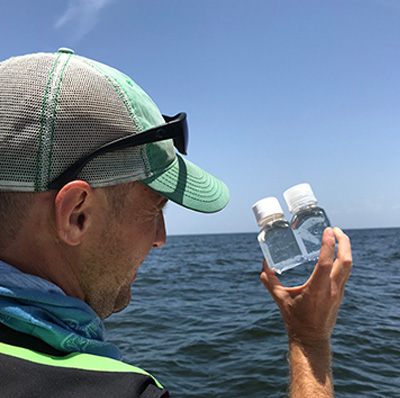 Scientist comparing water samples. (Florida Fish and Wildlife Conservation Commission)